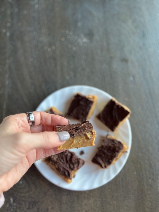 holding peanut butter and chocolate bar